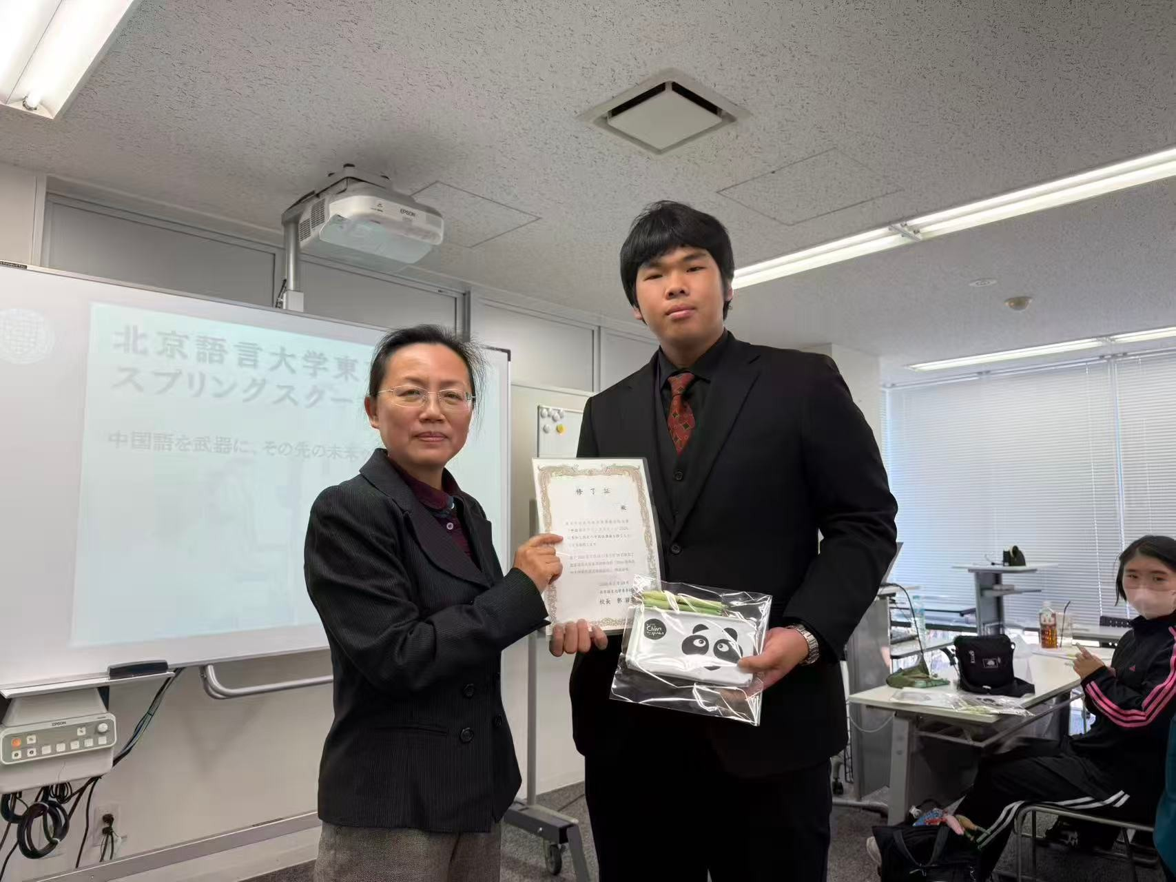 修了式で修了証を受け取る参加者