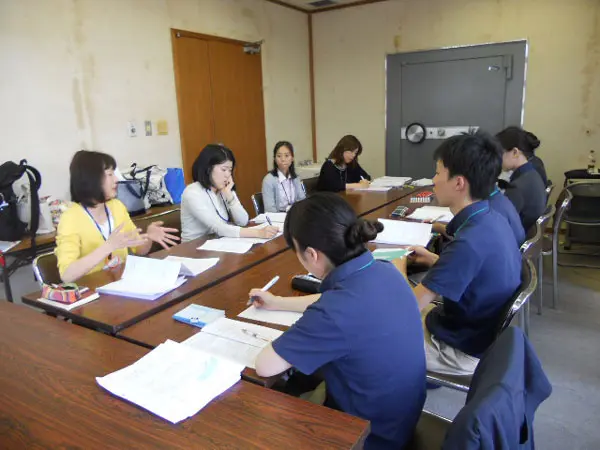 実習指導者から質問や助言を受ける学生